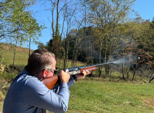 Senator Jon Husted standing with his hunting crossbow