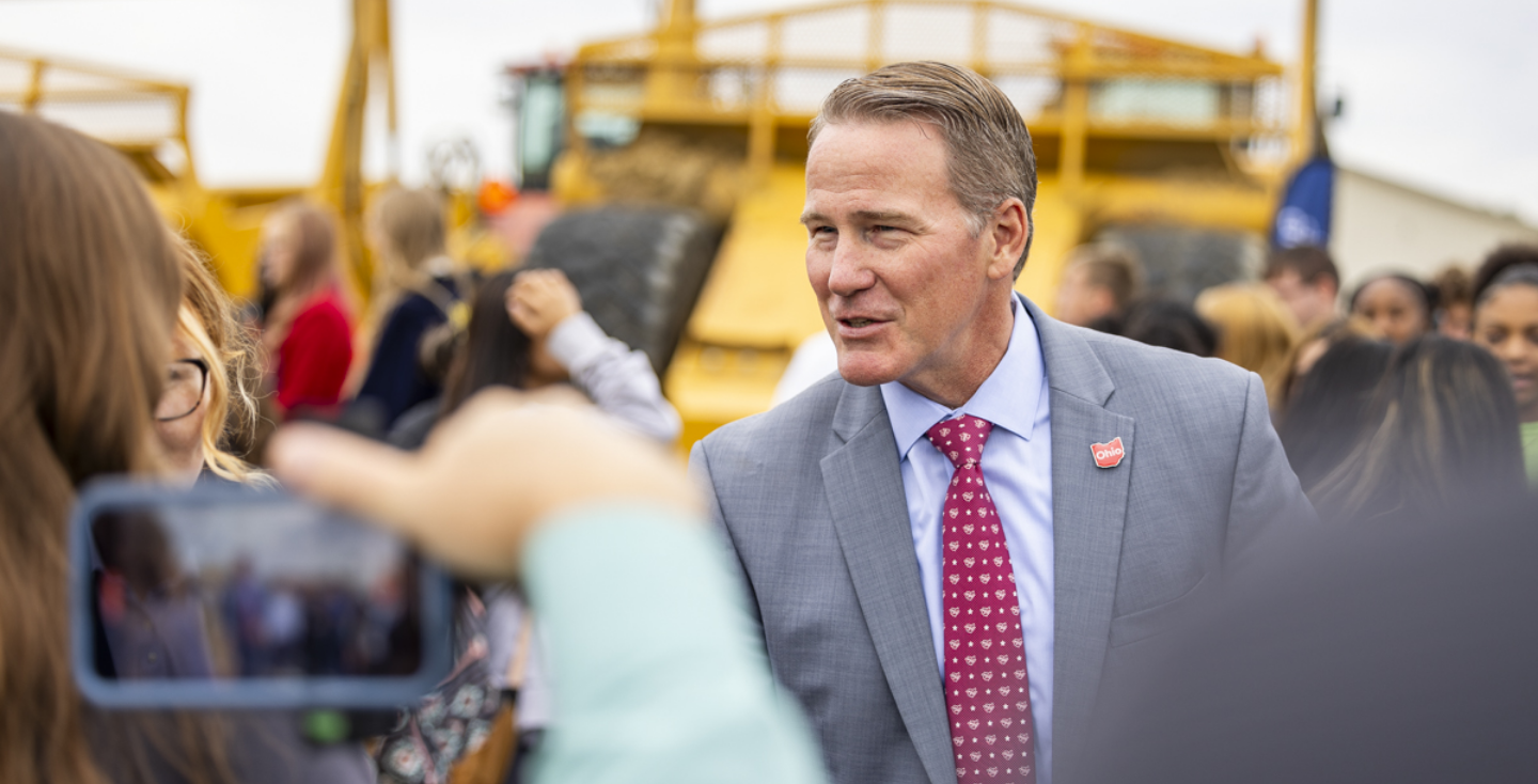 Senator Jon Husted speaking with construction workers