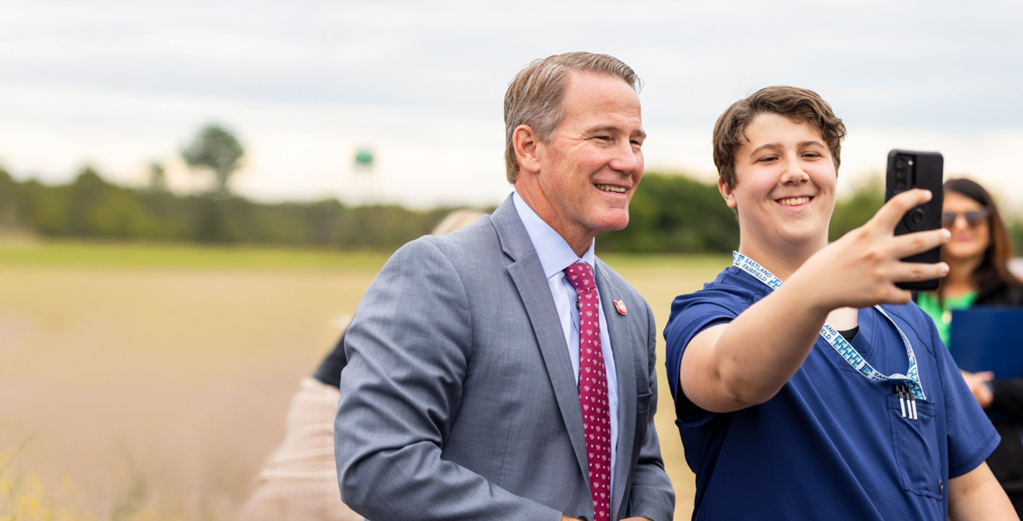 Senator Jon Husted taking a selfie with a young supporter