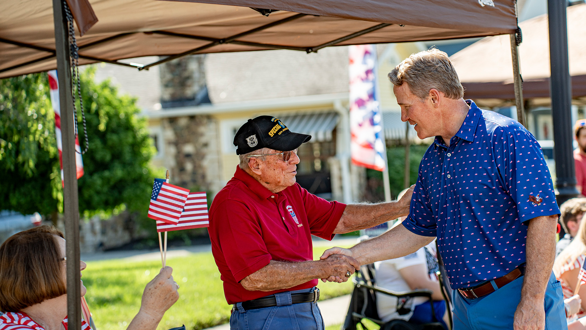 Senator Jon Husted shaking hands with a veteran