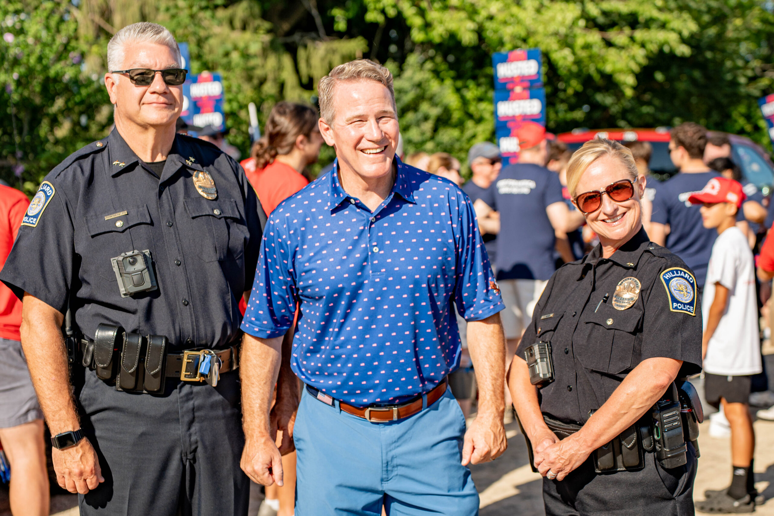 Senator Jon Husted smiling with law enforcement officers