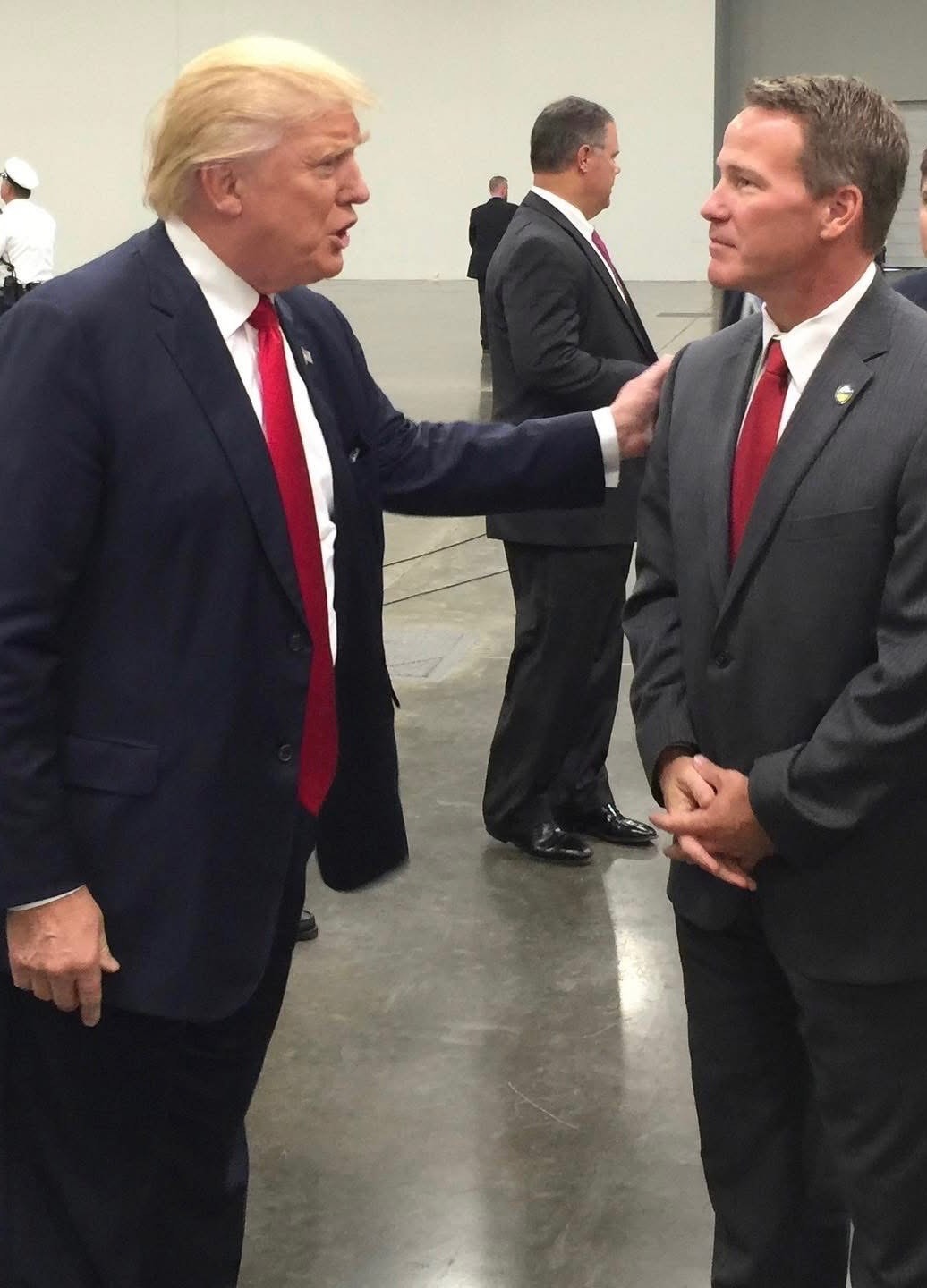 President Donald Trump putting his hand on Senator Jon Husted’s shoulder
