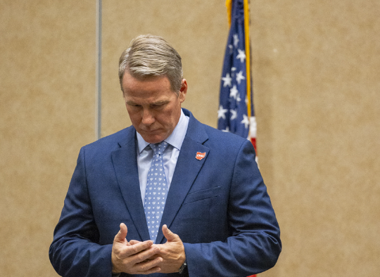 Senator Jon Husted bowing his head